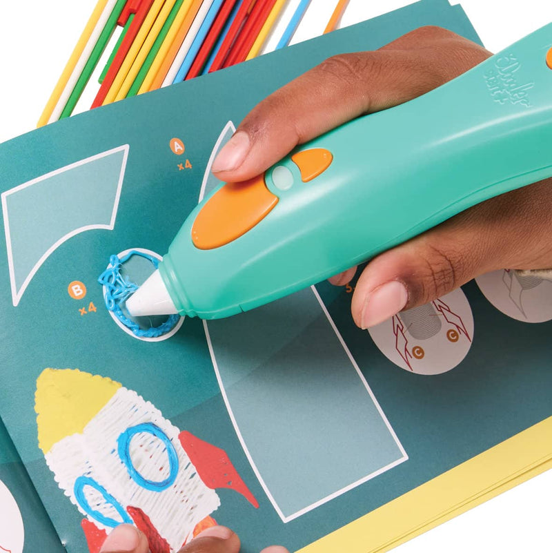 3Doodler Start+ 3D Pen tracing an activity guide on how to build a rocket ship model.